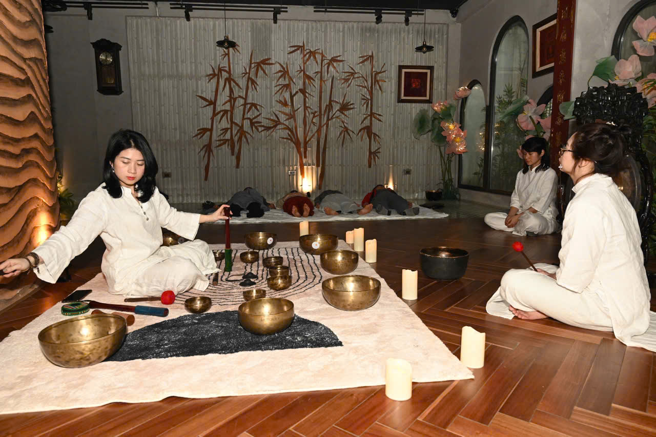 Giáo viên chuẩn bị chuông ngân và không gian cho buổi tắm âm thanh tại Metta Singing Bowl